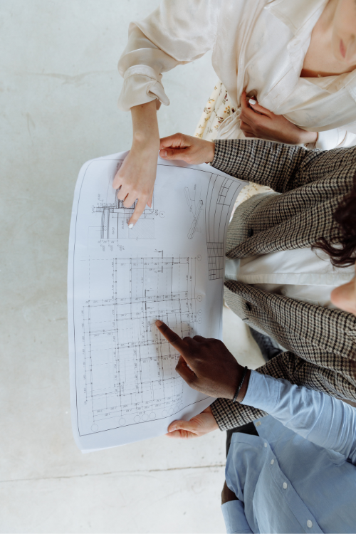 Photo of people holding blue prints